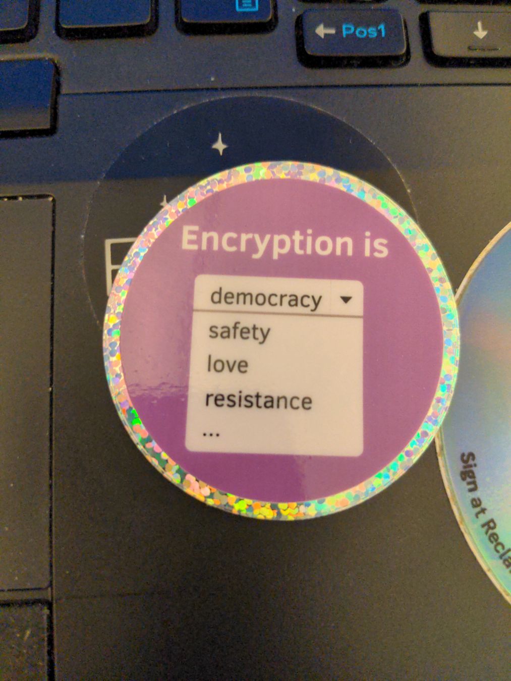 shiny sticker: "Encryption is - democracy - safety - love - resistance - …"